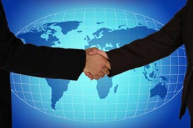 These hands clasping in front of world map symbolize our positive relationships with clients around the world.