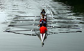 Crew team carving a path on flat water exemplifies the role of teamwork in getting to places you've never been before.